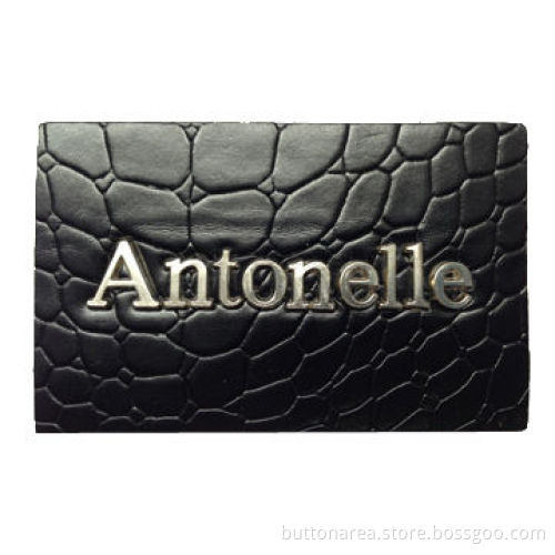 Imitation leather patch with alloy badge